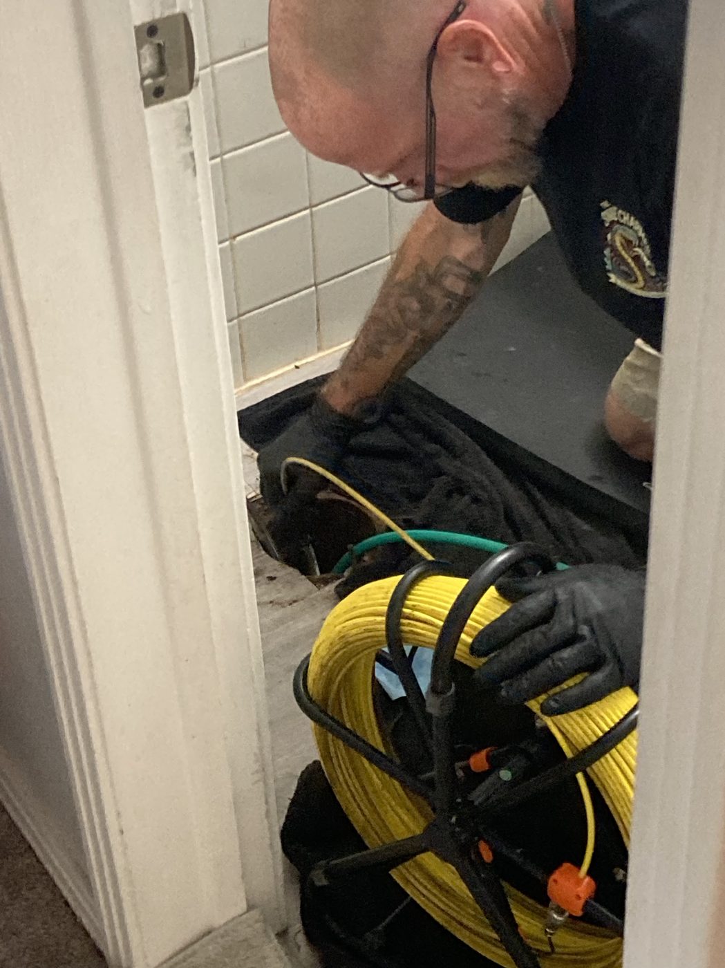 Sewer line camera inspection through a bathroom floor access point in Clearwater, FL